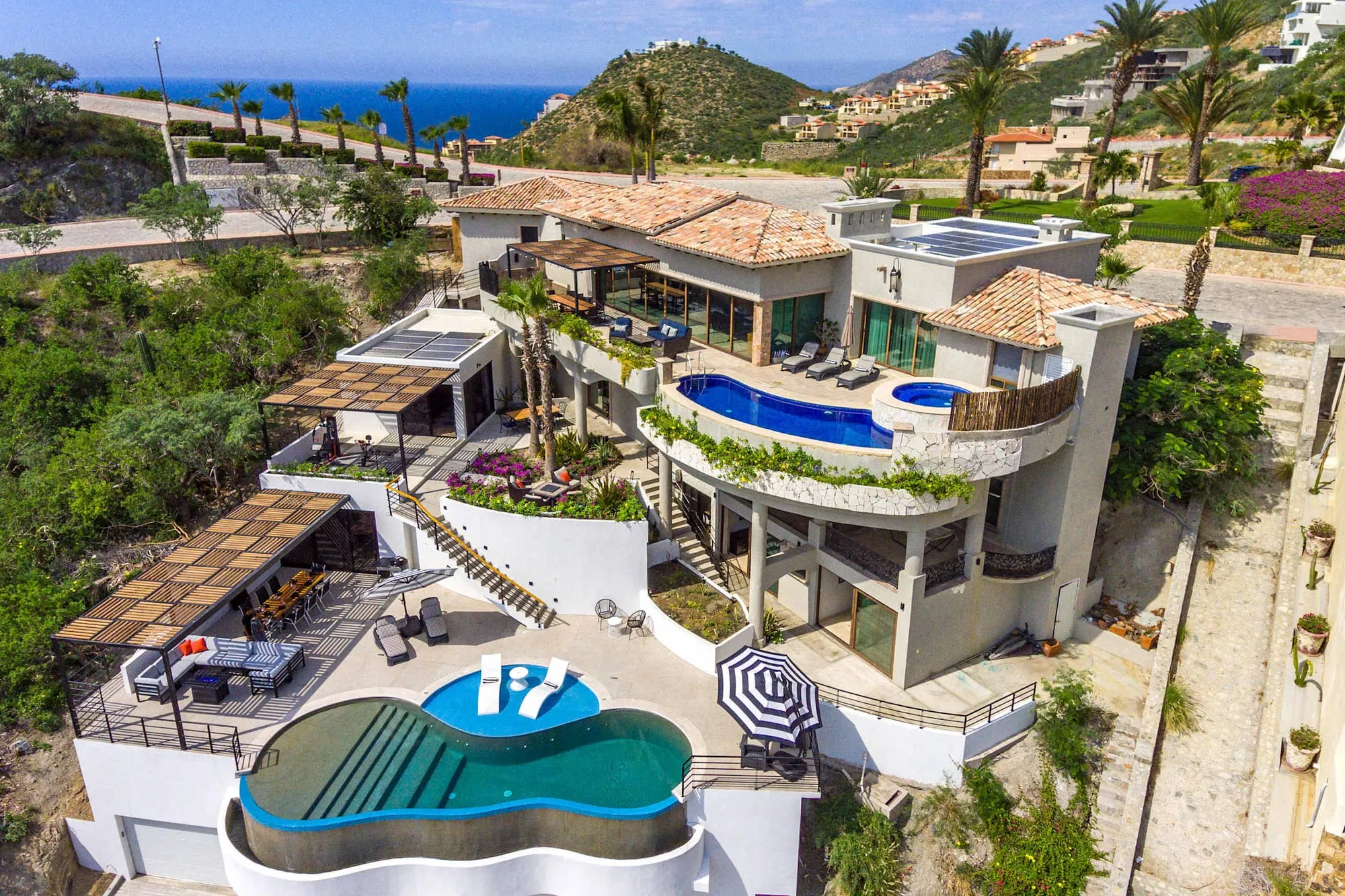 A villa in Pedregal from above — its pools and terraces, with the Pacific beyond