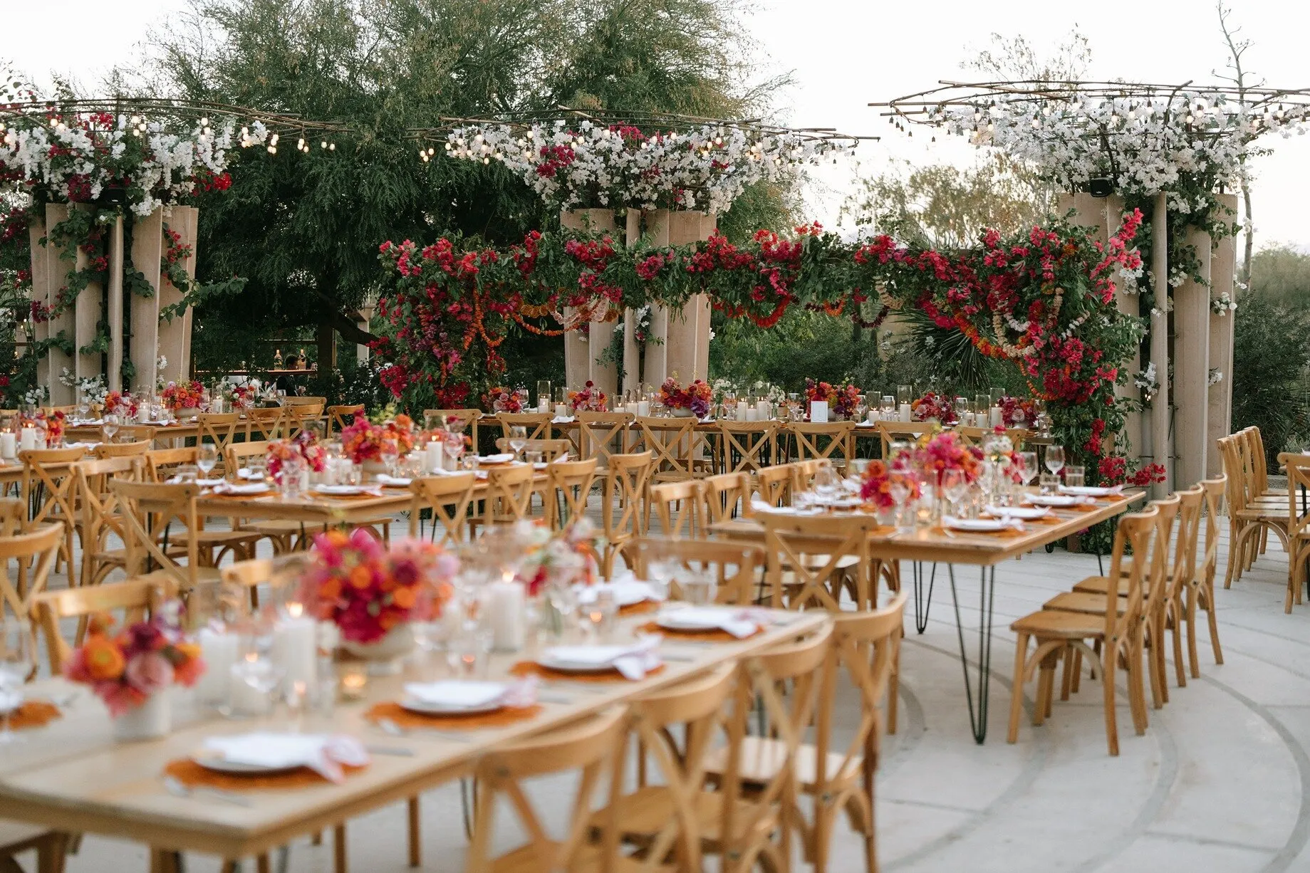 Reception tables laid under bougainvillea at Acre in San José del Cabo