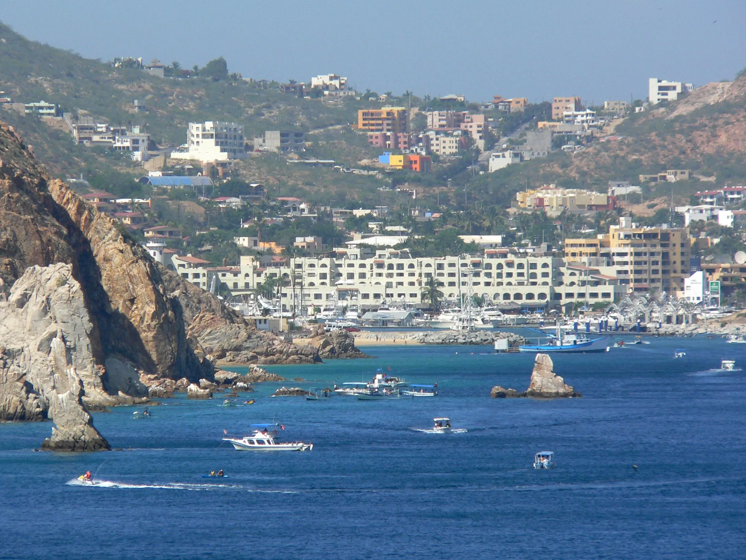 Hotels and houses on the hillside above the bay at Cabo San Lucas