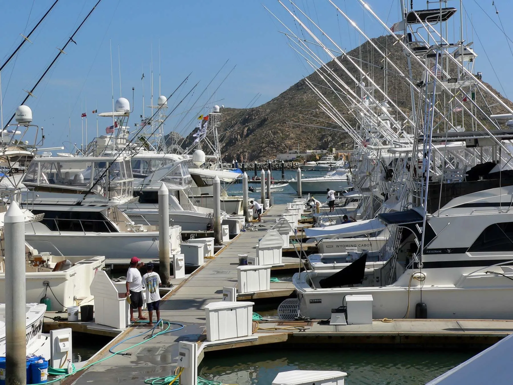 Sportfishing boats along the dock at Cabo San Lucas, the hills of Land’s End behind