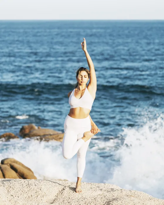 Paulina Carlon practising on the rocks above the surf