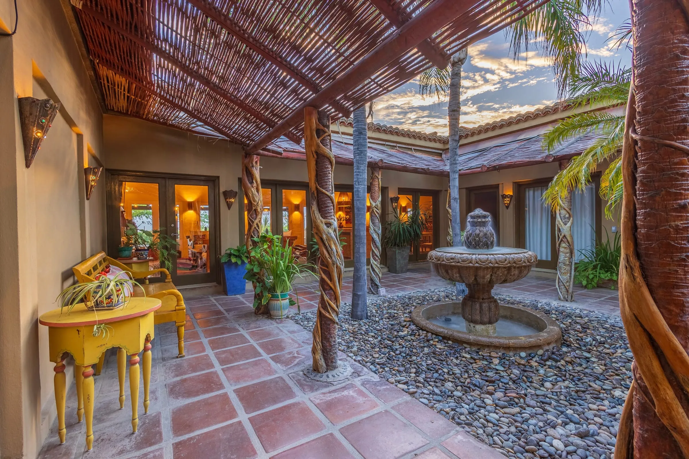 The interior courtyard with its fountain, under a palapa roof